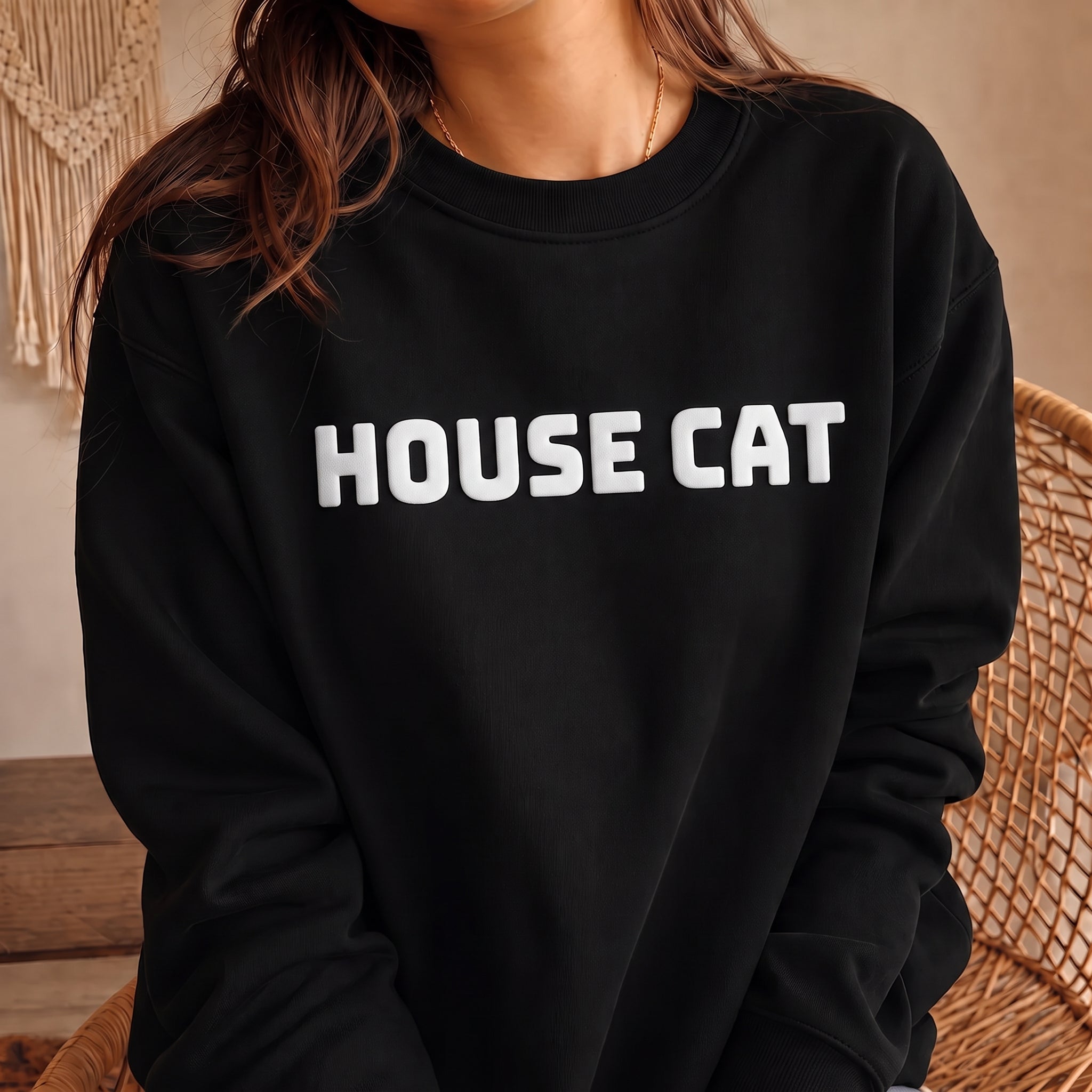 Black HOUSE CAT sweatshirt with raised white puff print text, minimalist cat lover crewneck with classic unisex fit and cozy fleece construction.