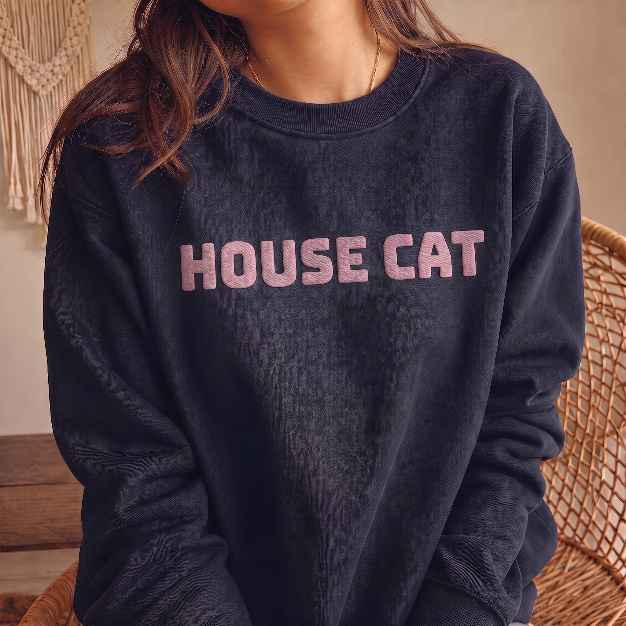 Woman modeling dark navy HOUSE CAT sweatshirt with raised puff print lettering, cozy graphic cat crewneck designed for cat lovers and everyday wear.