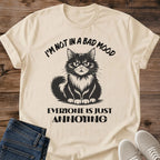 Sand Annoyed Cat Energy graphic T-shirt featuring a grumpy cat attitude design on a unisex crewneck