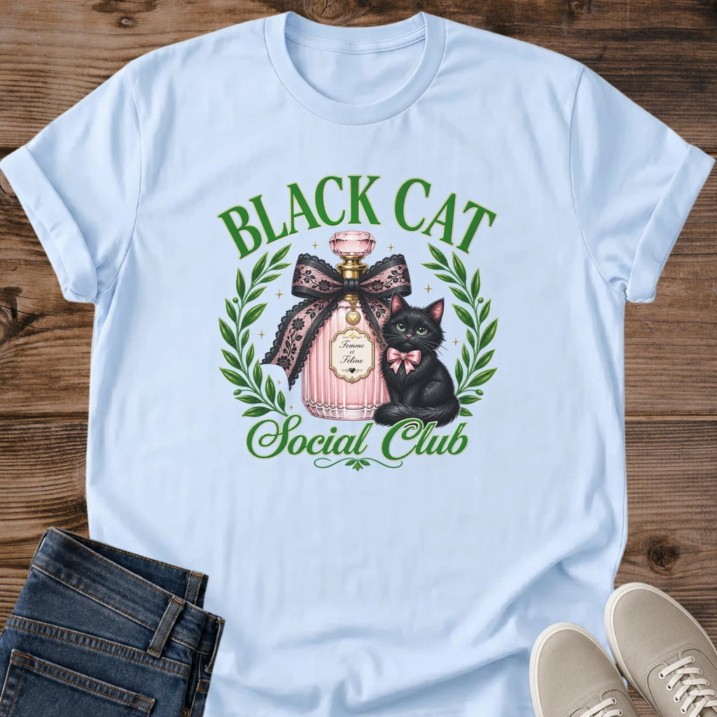 Black Cat Graphic Tee Coquette Aesthetic Design Feminine Cat Shirt With Perfume Bottle Art Green Eyes Cat Design Laurel Wreath Frame Pink Bow Detail Casual Wear Essential Cat Lover Gift Soft Girl Style Fashion Statement Unique Graphic