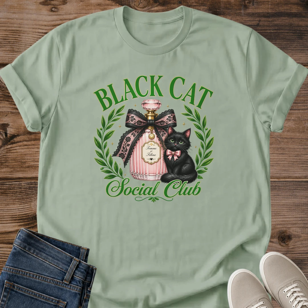 Cat Lover Gift Shirt Black Cat Graphic Design Aesthetic Tee With Perfume Bottle Art Coquette Style Fashion Green Eyes Cat Detail Pink Bow Accent Laurel Wreath Frame Feminine Casual Wear Soft Girl Aesthetic Statement Piece Unique Design Gift