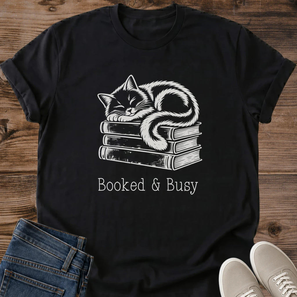 Literary Theme Shirt Casual Cotton Tee Featuring Hand Drawn Cat Design Atop Book Stack Soft Breathable Ring Spun Cotton Construction Comfortable Crew Neck Style Perfect Gift For Book Lovers Vintage Muted Contrast Artwork Cozy Bookish