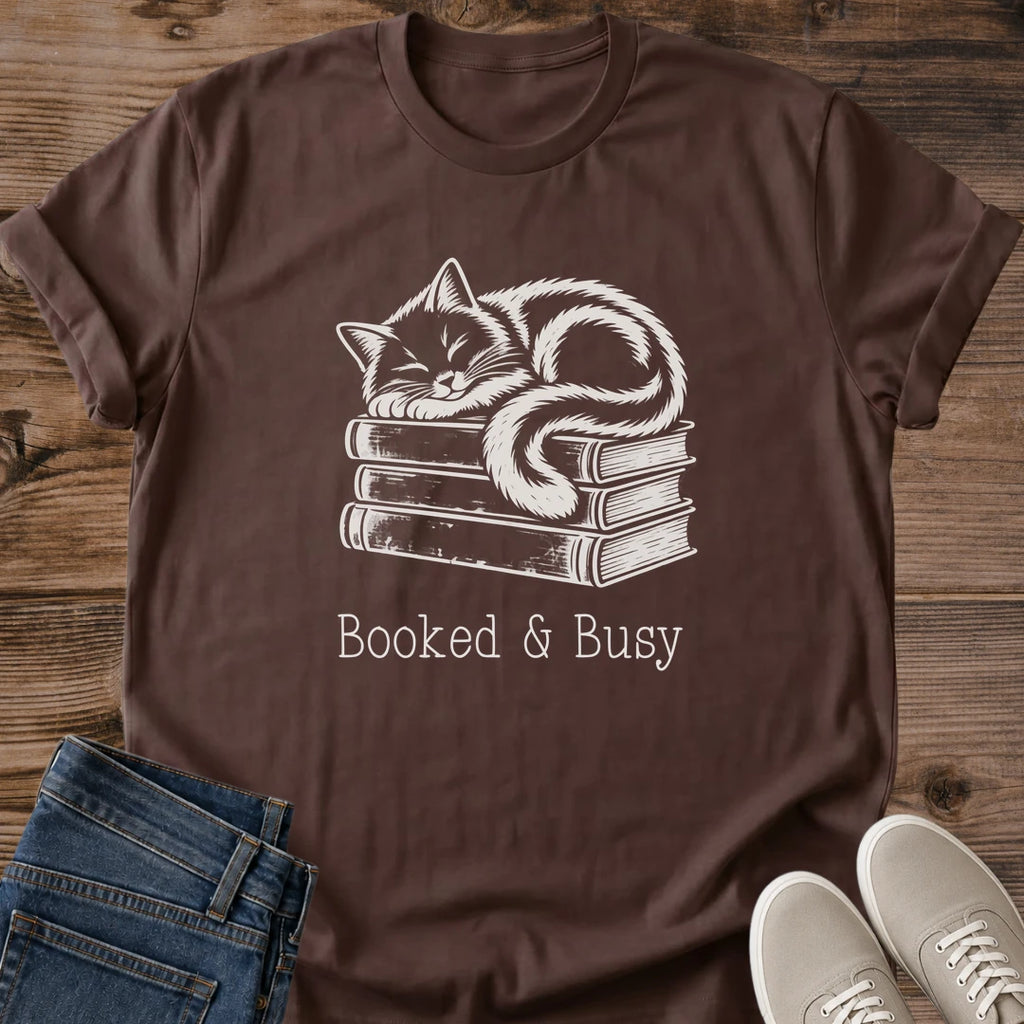 Bookworm Tee Shirt Soft Cotton Design Featuring Vintage Style Cat Illustration Atop Book Stack Hand Drawn Artwork Comfortable Crew Neck Construction Lightweight Breathable Ring Spun Cotton Perfect Gift For Literary Enthusiasts Cozy Reading