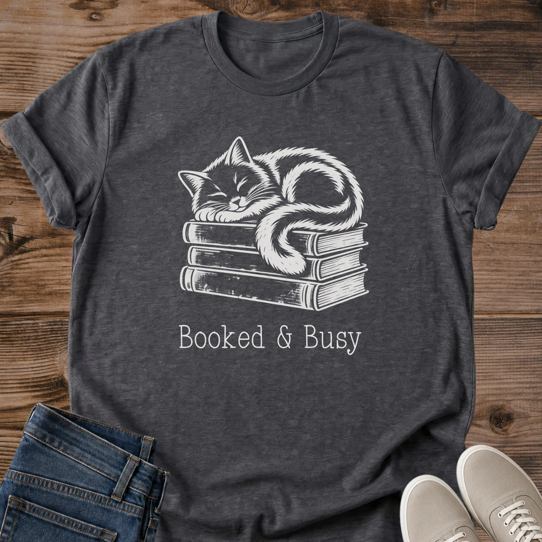 Book Lover Gift Tee Unique Hand Drawn Cat Illustration Design Atop Book Stack Soft Cotton Crew Neck Shirt Construction Comfortable Lightweight Ring Spun Cotton Vintage Style Muted Contrast Artwork Perfect Present For Literary Enthusiasts