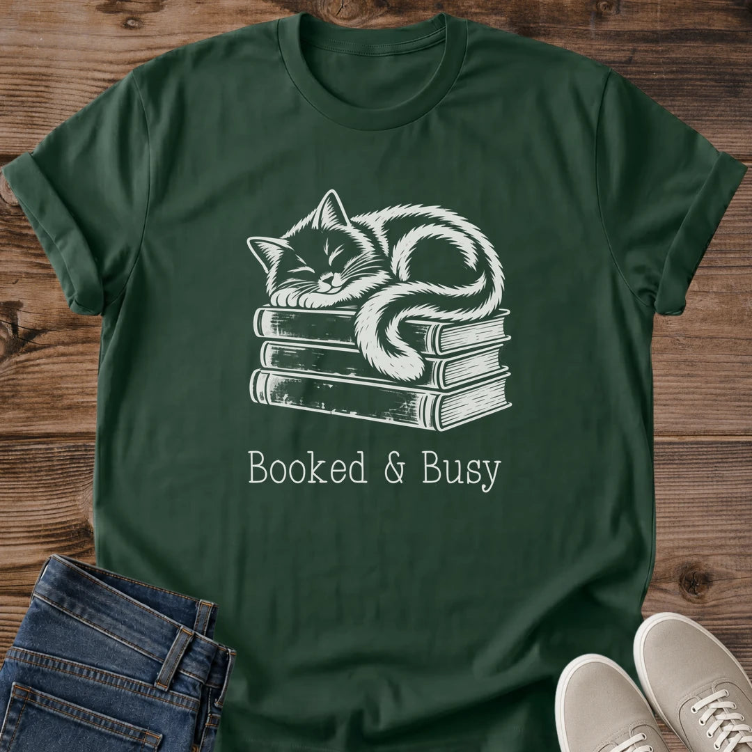 Reading Enthusiast Tee Soft Cotton Crew Neck Shirt Design Featuring Cozy Cat Illustration Atop Book Stack Hand Drawn Vintage Style Artwork Comfortable Lightweight Ring Spun Cotton Construction Perfect Gift For Book Lovers Casual Bookish
