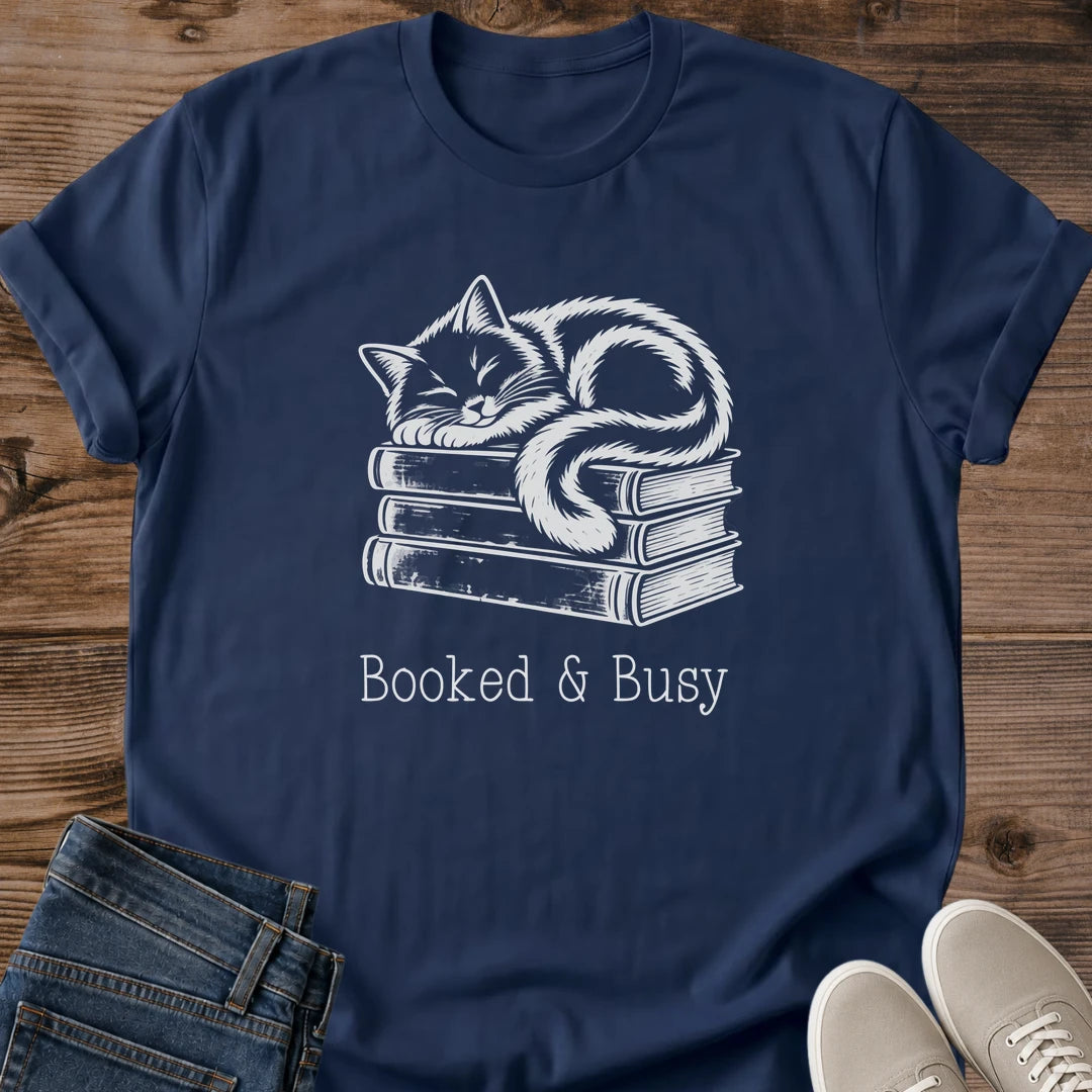 Cat Lover Gift Soft Cotton Crew Neck Tee Shirt Featuring Hand Drawn Cat Illustration Design Atop Book Stack Perfect Present For Book Lovers Comfortable Lightweight Ring Spun Cotton Construction Vintage Style Muted Contrast Artwork Cozy