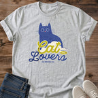 Cat Lover Shirt Blue Cat Graphic Tee Illustrated Design Soft Fabric Comfortable Fit Whimsical Art Retro Typography Wide Eye Cat Perfect Gift Idea Casual Weekend Wear Lightweight Material Everyday Essential Pet Parent Statement Piece Coffee