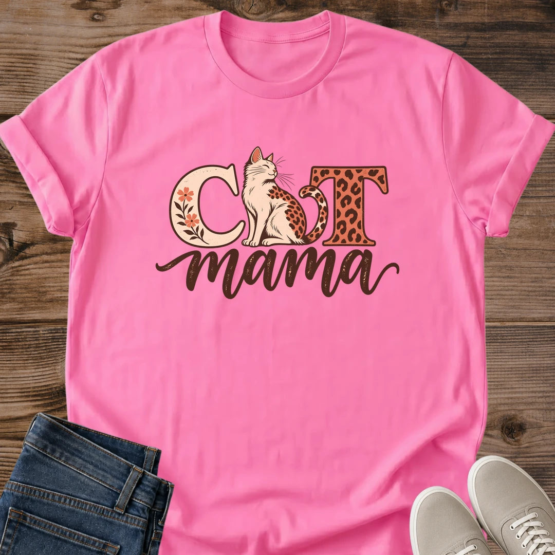 Azalea pink Cat Mama T-shirt flat lay with a cream seated cat, leopard spots, floral C, leopard-print T and flowing brown mama lettering.