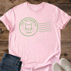 Subtle Cat Graphic Tee Vintage Postmark Design Minimalist Sage Green Shirt Aesthetic Feline Tee Cat Face Stamp Graphic Vintage Cat Lover Shirt Soft Green Minimalist Style Contemporary Cat Design Tee Understated Fashion Statement Modern