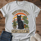 Plant Parent Gift Shirt Vintage Cat Graphic Tee Soft Cotton Fabric Comfortable Casual Wear Black Cat Houseplant Design Retro Sunset Background Crew Neck Style Perfect For Cat Lover Plant Enthusiast Cozy Everyday Outfit Botanical Theme