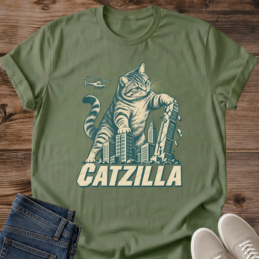 Military green Catzilla giant cat graphic T-shirt featuring a tabby cat towering over an urban skyline