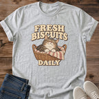 Cat In Basket Shirt Fresh Biscuits Daily Funny Cat Tee Hand Drawn Sleepy Tabby Sketch Bold Retro Bakery Lettering Cat Owner Shirt Gift For Cat Lovers Farmhouse Kitchen Tee Cozy Baking Shirt Unisex Ringspun Cotton Shirt Cat Whisker Co