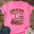 Azalea pink Hang In There Gator cat T-shirt with vintage tabby above an alligator and “It gets worse” sarcastic graphic