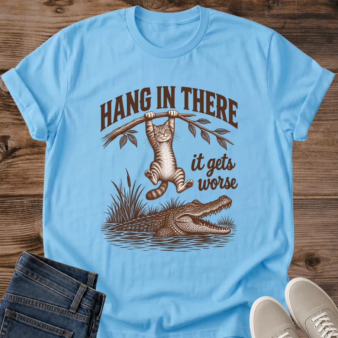 Sky blue Hang In There Gator cat T-shirt with vintage tabby above an alligator and “It gets worse” sarcastic graphic