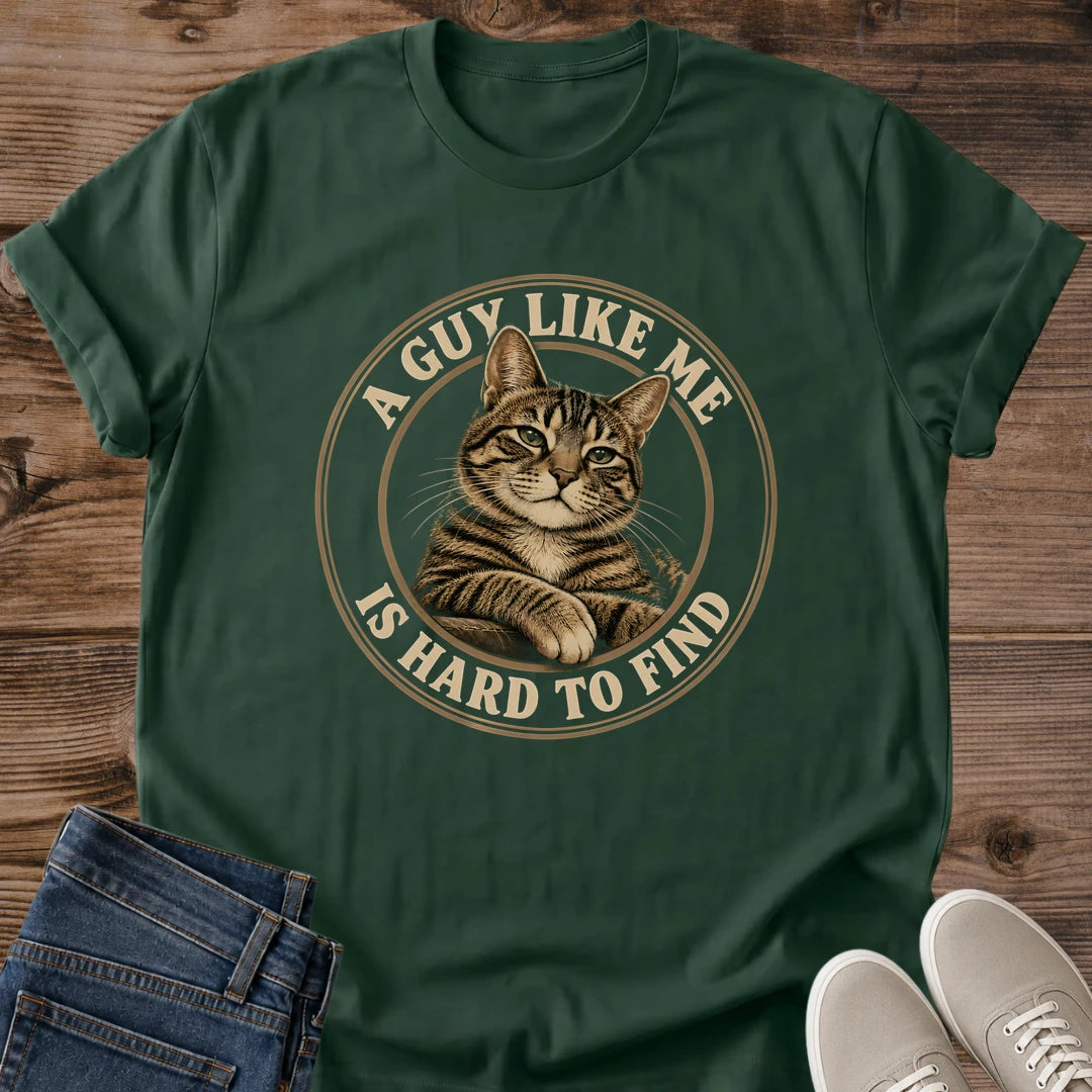 Forest Green T-shirt flat lay featuring a brown tabby with crossed front paws inside a tan circular border reading A Guy Like Me Is Hard to Find.