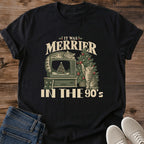 Black It Was Merrier in the 90s cat Christmas graphic tee with cats beside a retro TV in a nostalgic holiday scene