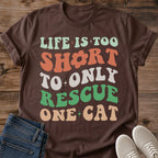 Cat Lover Gift Shirt Funny Multi Cat Owner Tee Retro Groovy Design Typography Style Wavy Text Pattern Rescue Philosophy Statement Sage Green Coral White Palette Cat Mom Dad Present Casual Wear Vintage Fashion Animal Shelter Volunteer
