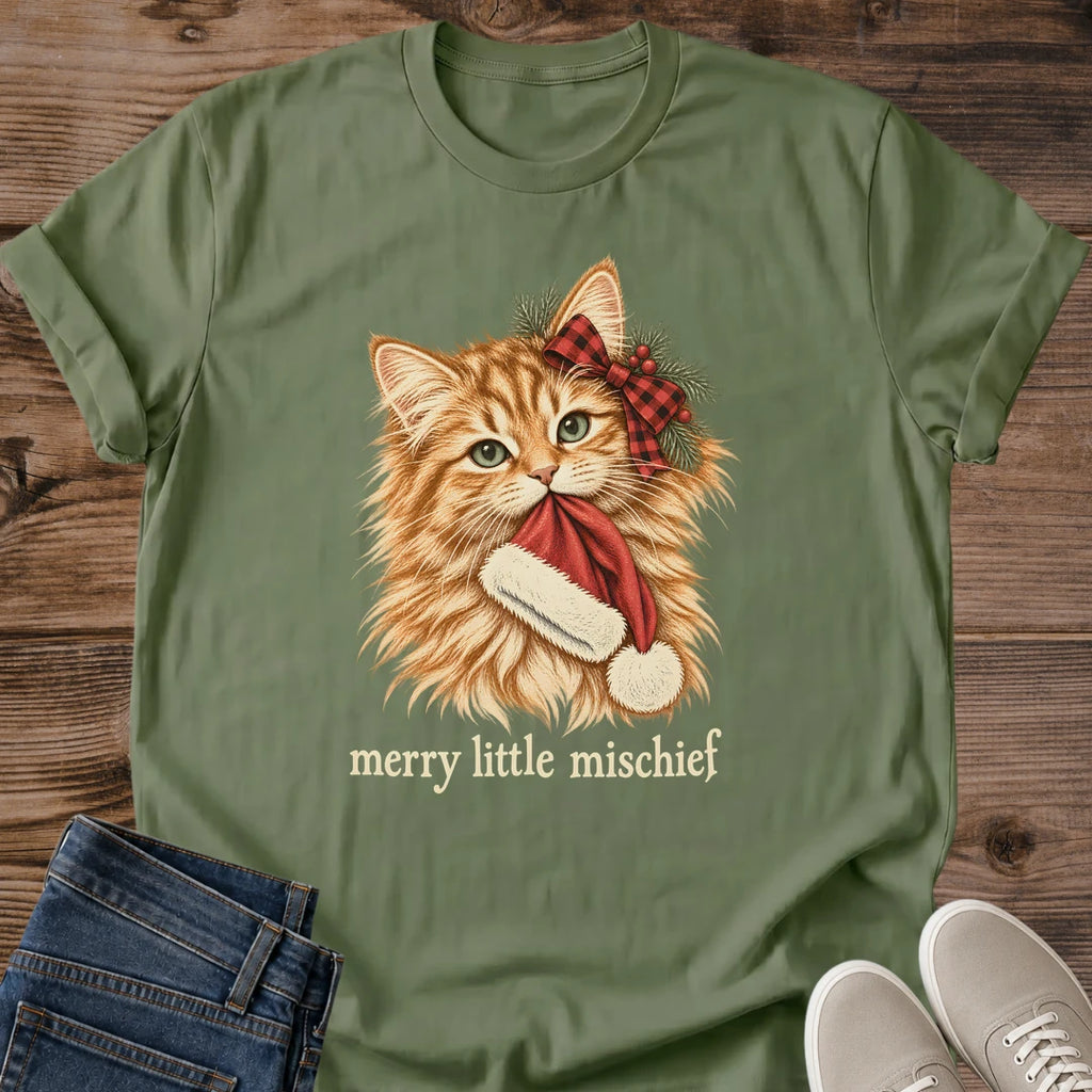 Military green Merry Little Mischief Christmas cat T-shirt flat lay featuring an orange tabby with a red plaid bow holding a Santa hat.