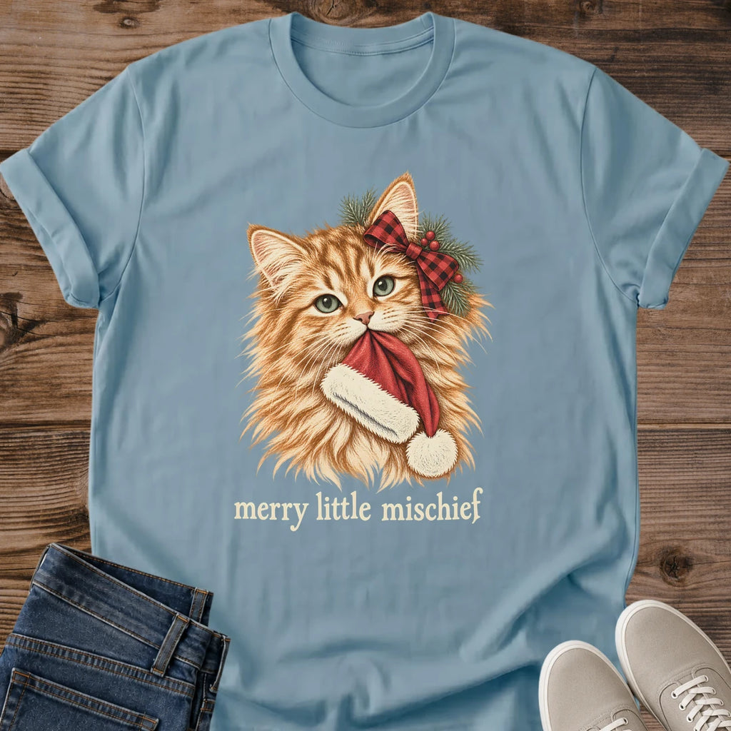 Stone blue Merry Little Mischief Christmas cat T-shirt flat lay featuring an orange tabby with a red plaid bow holding a Santa hat.