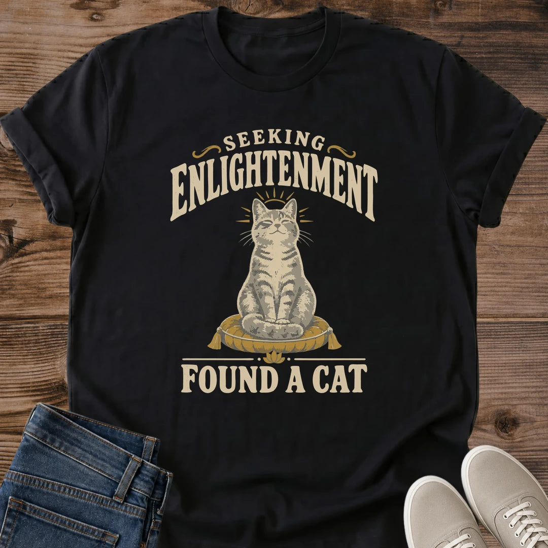 Vintage Style Cat Tee Spiritual Humor Graphic Shirt Seeking Enlightenment Design Funny Cat Lover Gift Lightweight Cotton Fabric Comfortable Casual Wear Muted Warm Tones Dark Background Centered Cat Illustration Quirky Novelty Shirt Everyday