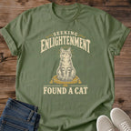 Vintage Graphic Cat Shirt Quirky Statement Tee Spiritual Humor Design Funny Cat Lover Gift Soft Cotton Fabric Comfortable Everyday Wear Seeking Enlightenment Message Muted Tones Dark Background Centered Illustration Casual Wardrobe