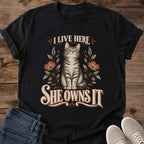 BlackVintage Cat Lover Tee I Live Here She Owns It Floral Design Cotton Cat Dad Gift Shirt Funny Aesthetic Softstyle Ring Spun Fabric Relaxed Retail Fit Casual Weekend Layering Statement Piece Everyday Wear For Home And Away
