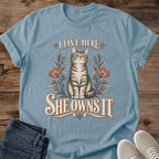 I Live Here She Owns It Cat Shirt Funny Floral Cat Tee Cat Lover Gift Idea Softstyle Ring Spun Cotton Relaxed Fit Everyday Casual Wear Vintage Print Cat Owner Apparel Statement Piece Lightweight Layering For Home