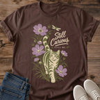 Botanical Cat Graphic Tee Nature Inspired Artistic Design Soft Cotton Casual Shirt Curious Cat Peeking Through Hand Drawn Plants Comfortable Everyday Wear Lightweight Breathable Fabric Muted Botanical Illustration Handwritten Typography