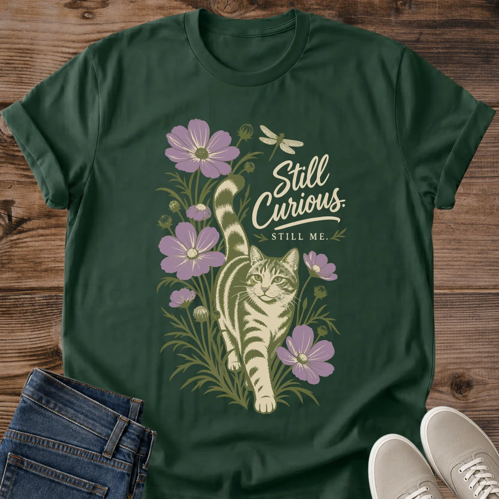 Artistic Cat Tee Hand Drawn Botanical Design Soft Comfortable Cotton Shirt Curious Cat Illustration Peeking Through Foliage Nature Inspired Graphic Print Muted Color Palette Handwritten Still Curious Typography Lightweight Casual Wear