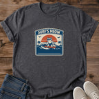 Cat Surfing Shirt Retro Beach Tee Orange Tabby Design Vintage Surf Graphic Funny Cat Lover Gift Unisex Cotton Tshirt Sunset Wave Design Teal Coral Pink Palette Natural Sand Color Soft Lightweight Fabric Beach Lifestyle Apparel Summer