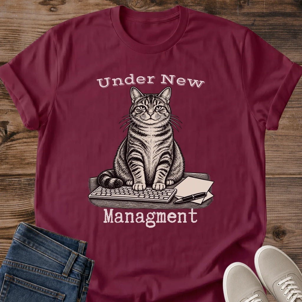 Close Up Collar View Of Under New Management Cat Tee Showing Typewriter Style Lettering On Soft Gildan 64000 Softstyle Unisex Shirt Funny Cat On Keyboard Design Office Cat Shirt White Elephant Gift Cat Whisker Co