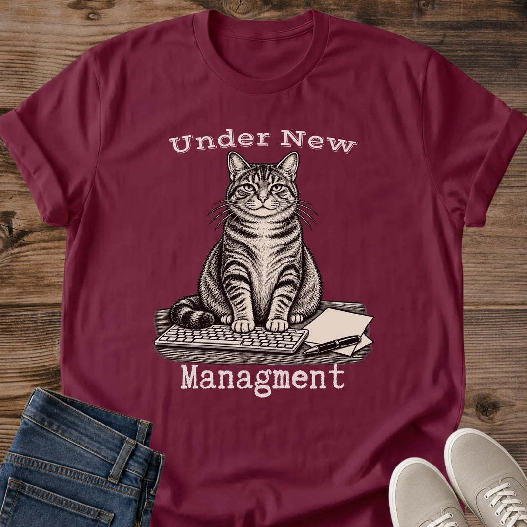 Close Up Collar View Of Under New Management Cat Tee Showing Typewriter Style Lettering On Soft Gildan 64000 Softstyle Unisex Shirt Funny Cat On Keyboard Design Office Cat Shirt White Elephant Gift Cat Whisker Co