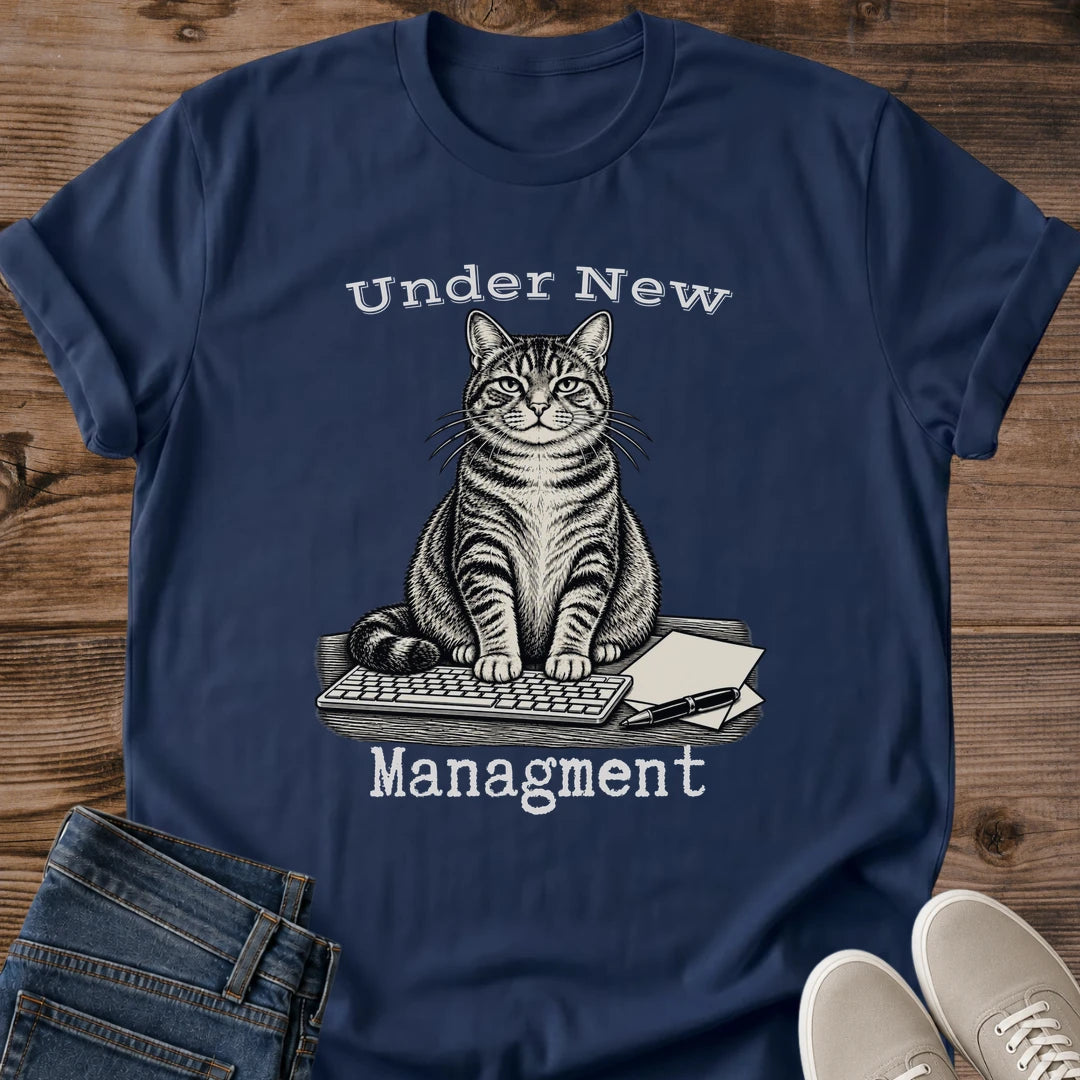 Under New Management Cat Shirt In Black Funny Work From Home Tee With Vintage Engraved Tabby Cat Sitting On A Keyboard And Paperwork Typewriter Lettering Cat Boss Graphic Tee Gildan 64000 Softstyle Cat Whisker Co